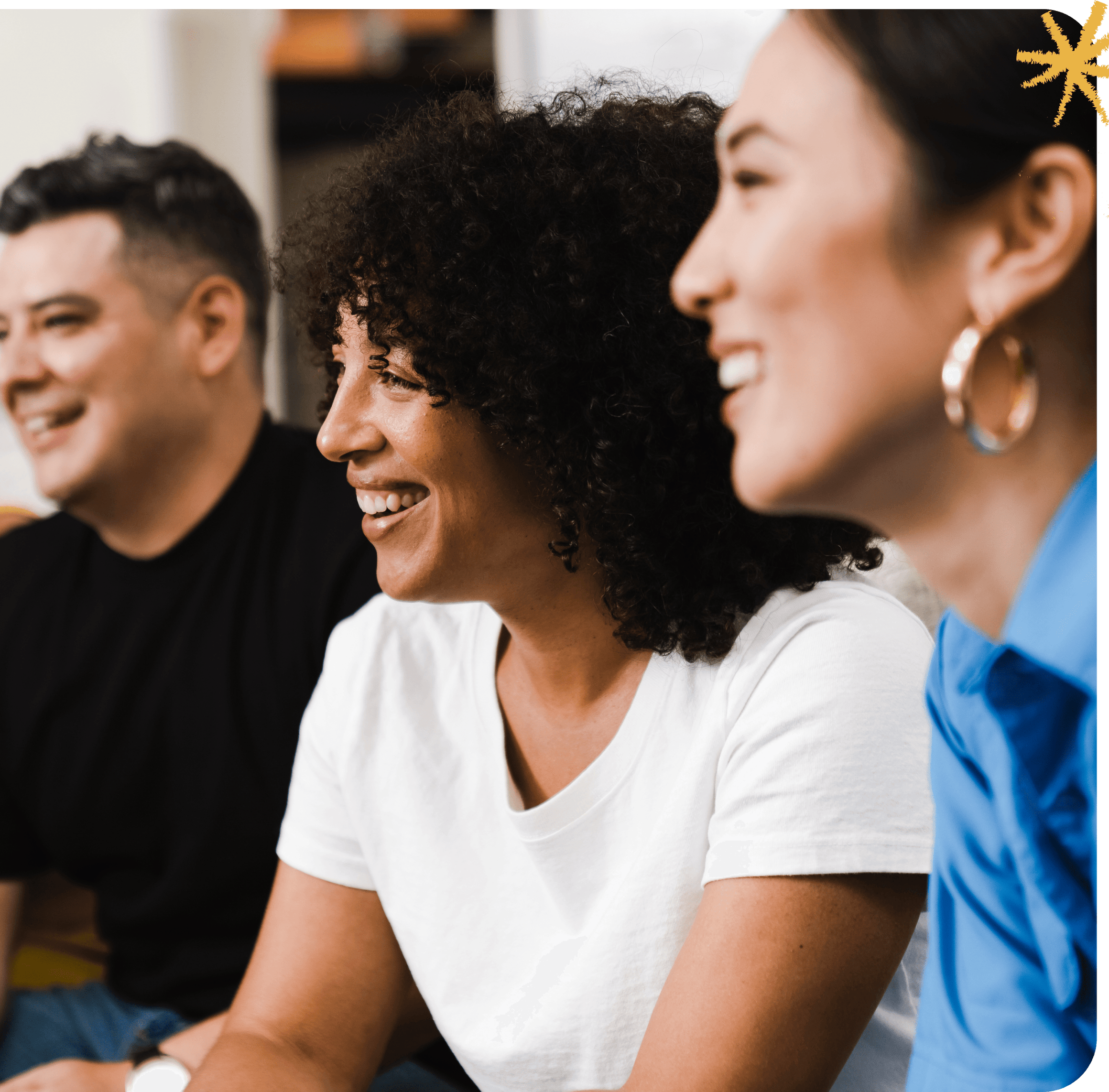 Next Shift Learning brand visual: a photograph of three teammates smiling and laughing together, framed by a teal border with a small yellow accent mark